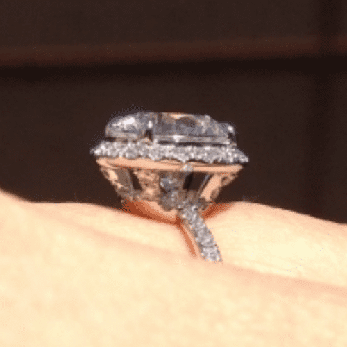 Profile of a diamond ring in halo on a finger.