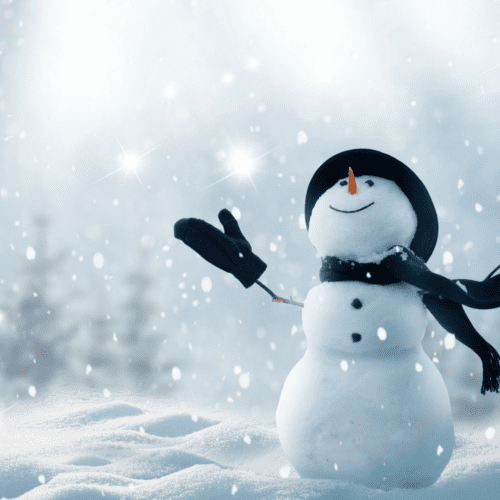 Snowman with arms lifted and head thrown back to look up. on a snowy field with trees in the background.