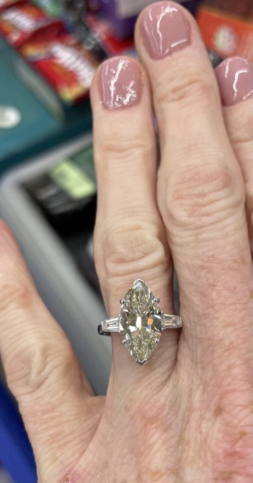 large marquise diamond ring on a finger