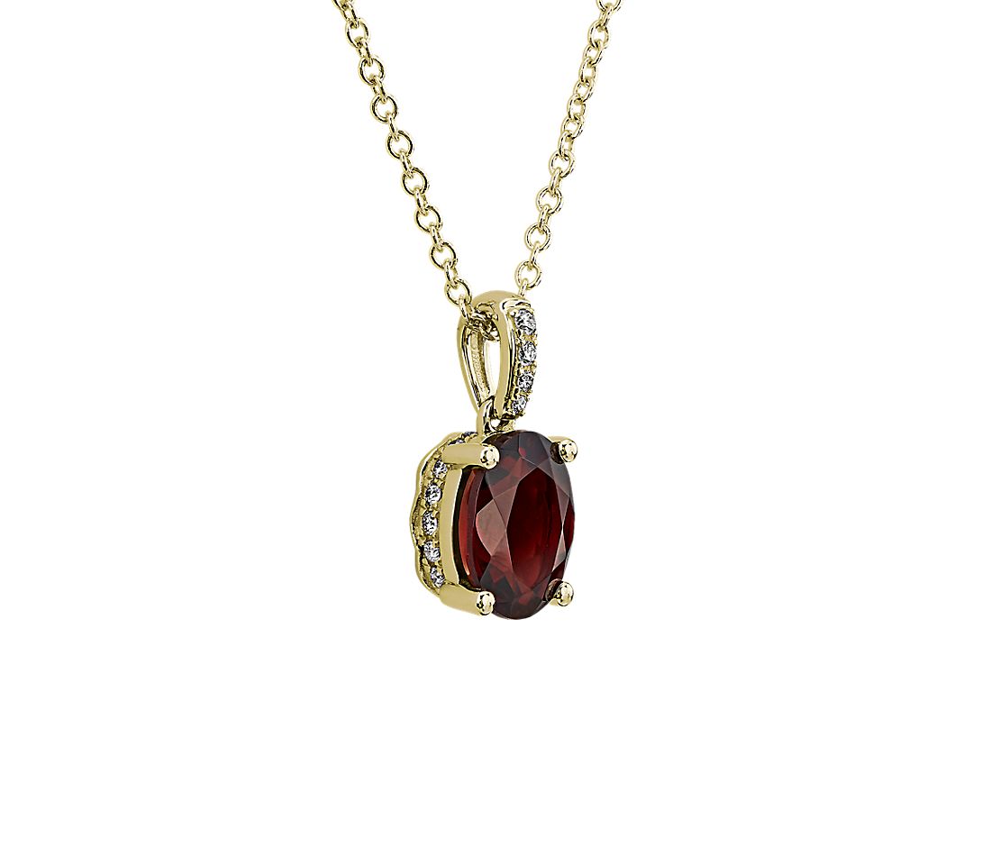 Oval Garnet and Diamond Pendant in 14k Yellow Gold.