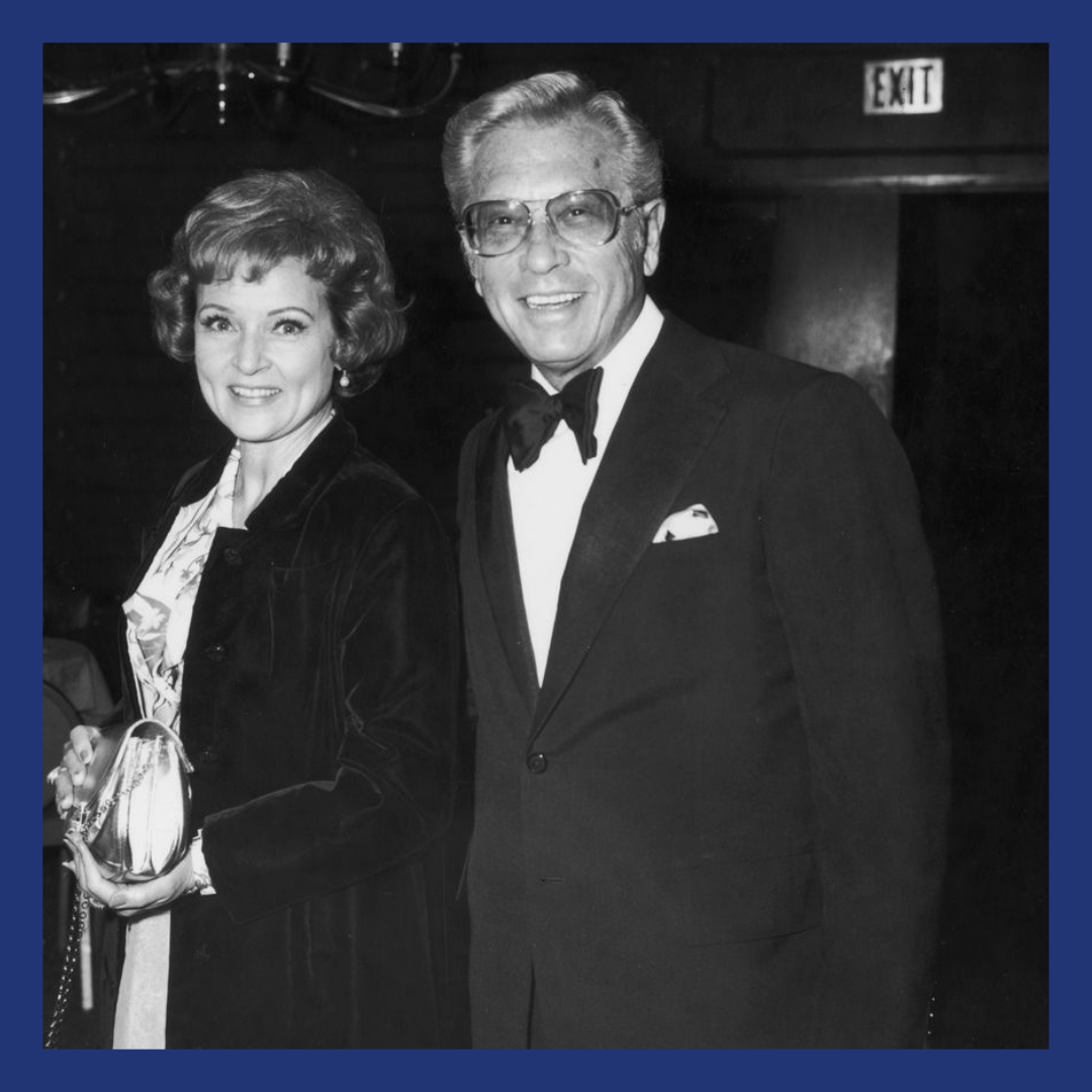 Black and white image of a couple leaving a black tie event.