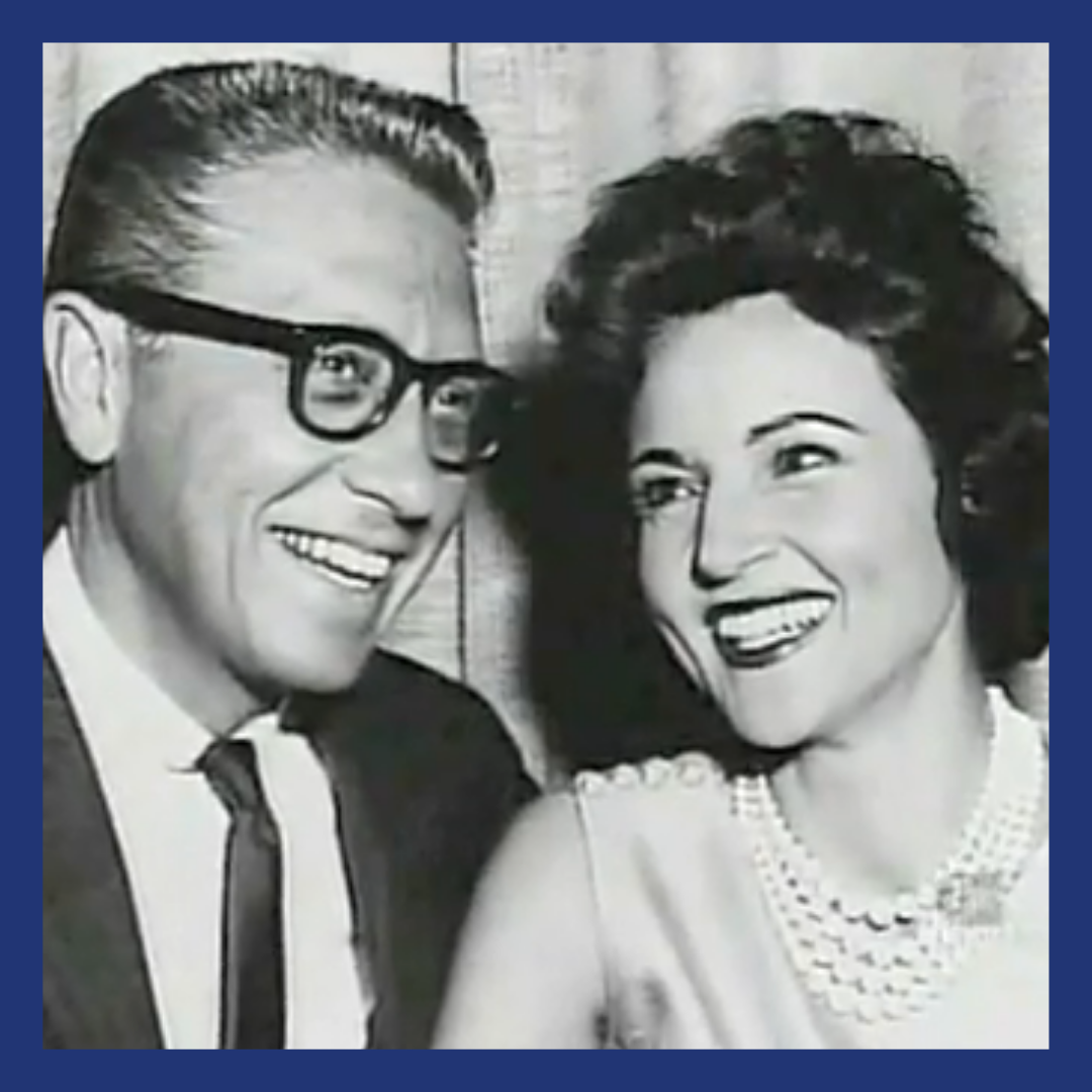 Black and white image of a couple smiling.