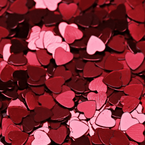 Close up of red heart confetti.