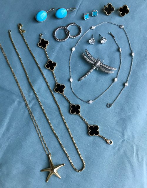 A collection of jewelry on a blue cloth.