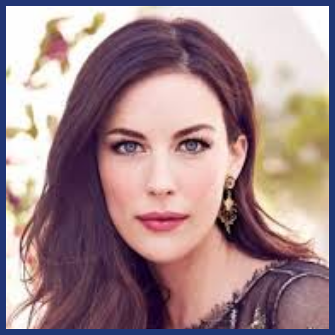 White woman with dark hair looks at viewer.