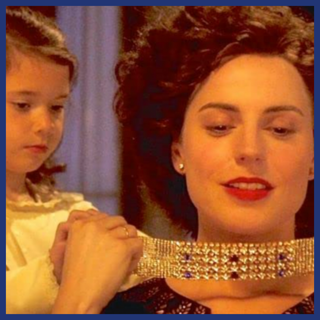 Young girl helping a woman in an incredible diamond choker.