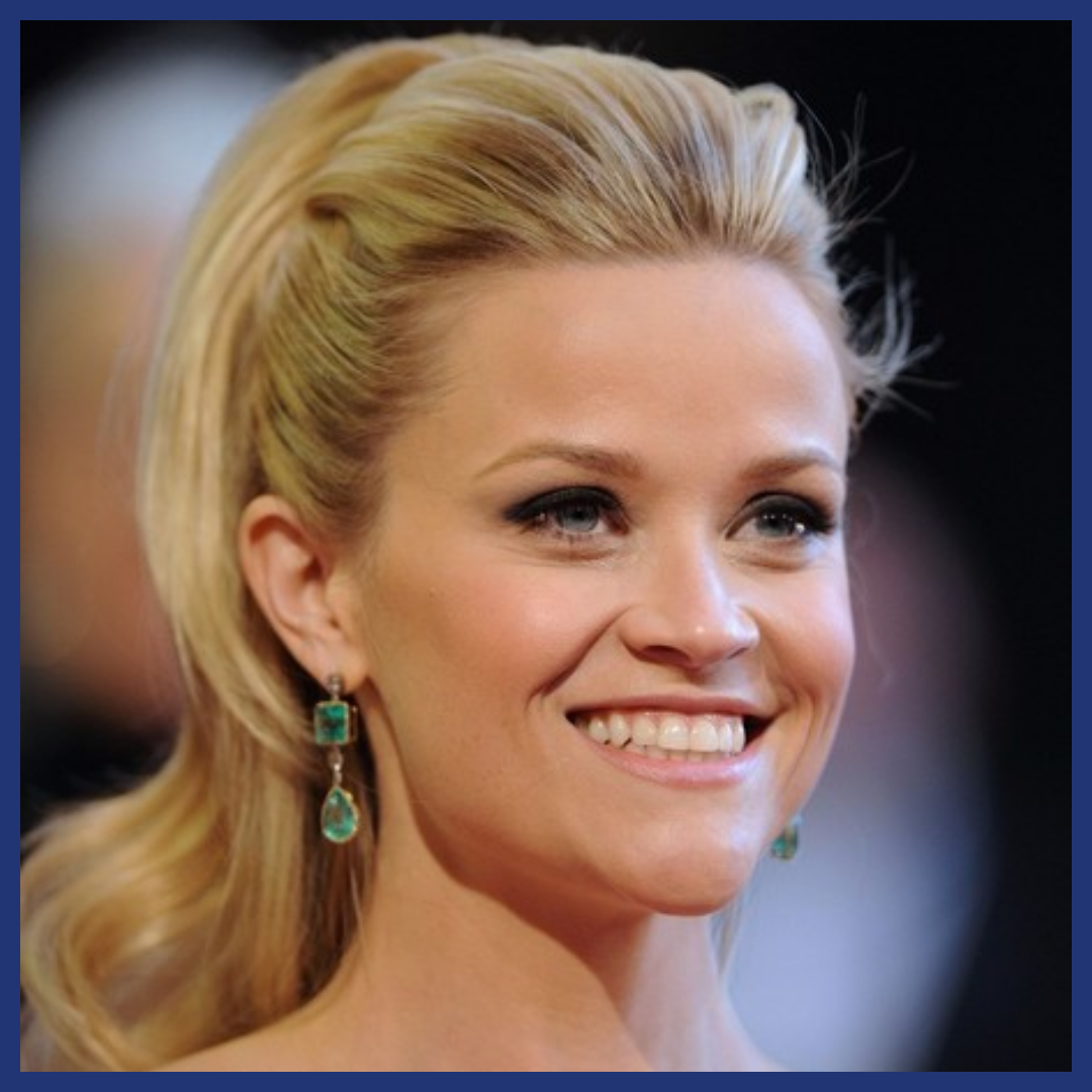Blonde woman smiling to the right of the viewer.