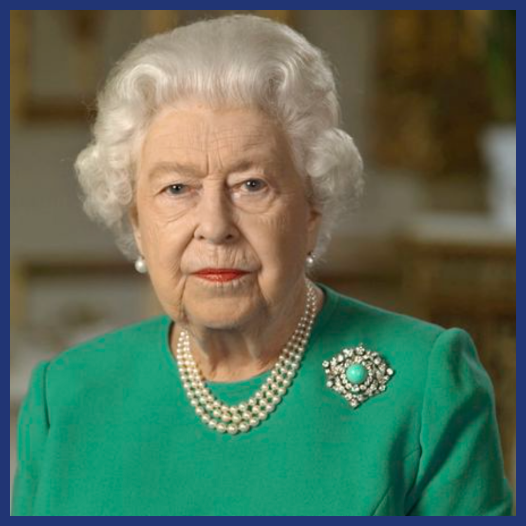 Queen Elizabeth II in her nineties wearing green with a turquoise and diamond brooch.