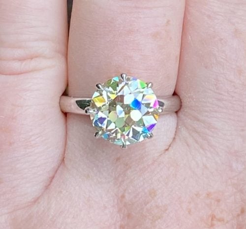 Diamond ring on a finger.