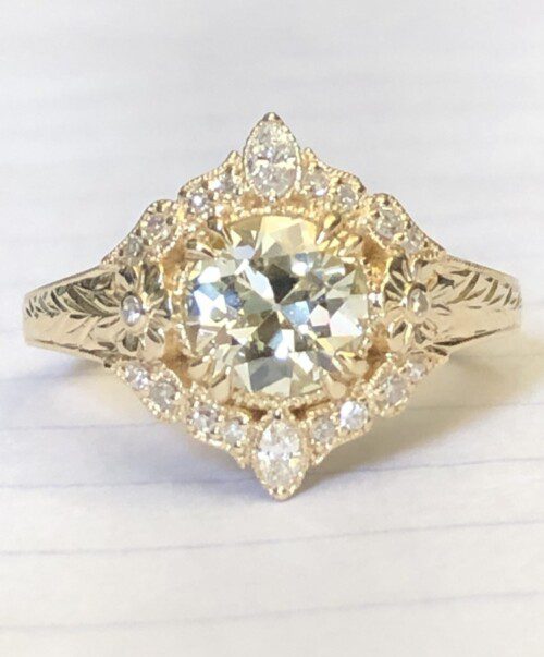 OEC/Transitional diamond in yellow gold floral halo setting.