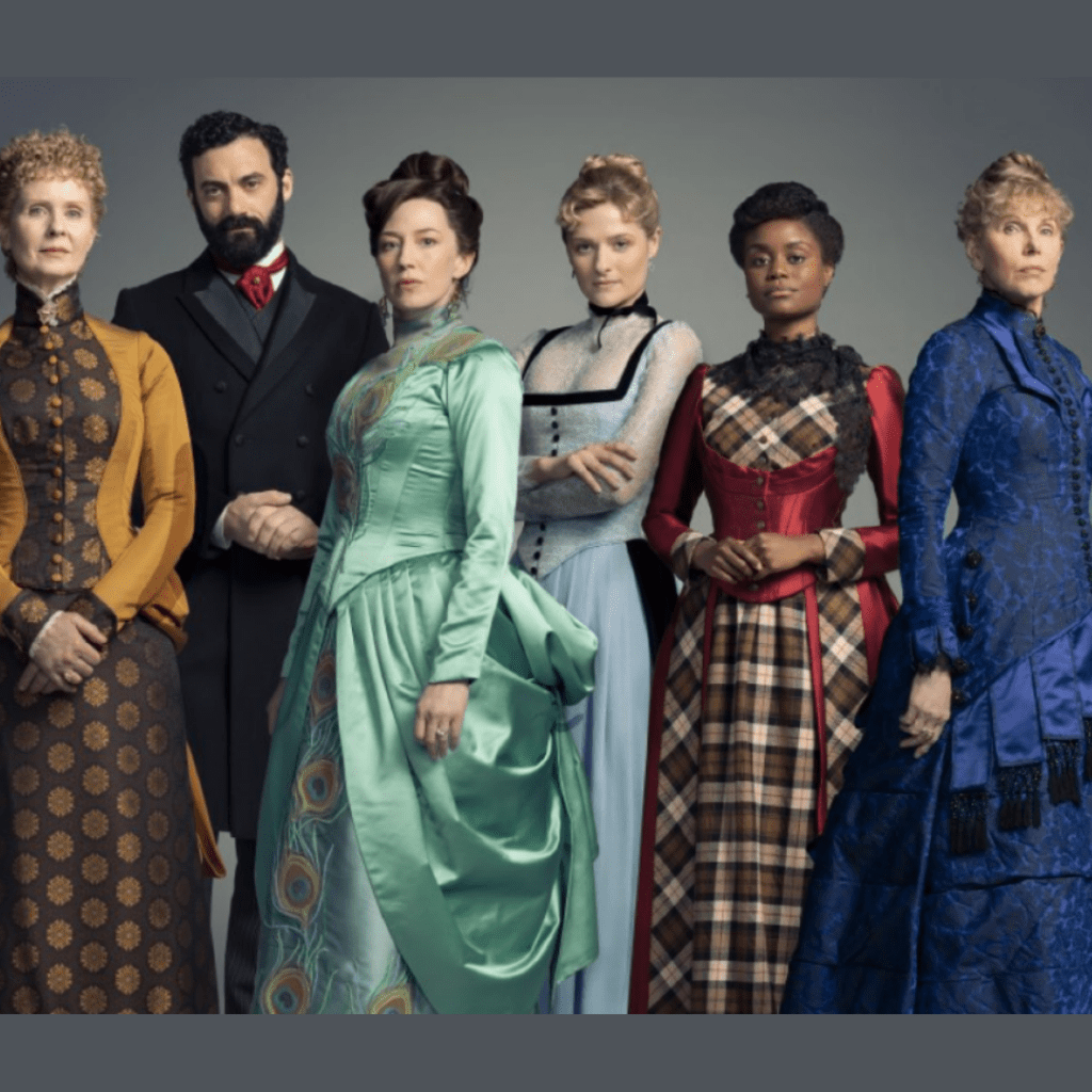 Five women and one man in Gilded Age costumes