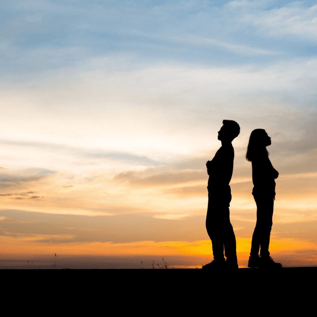 Couple with sunset in the background.