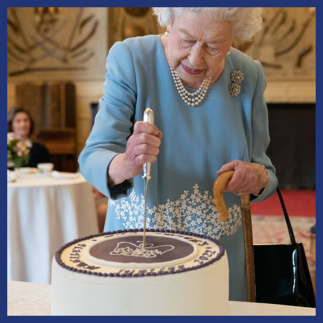 Queen Elizabeth II cutting a cake to mark her Platinum Jubilee.