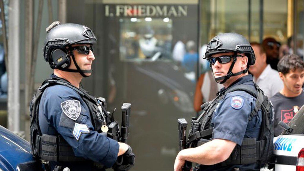 Two armed police officers outside of a jewellery shop