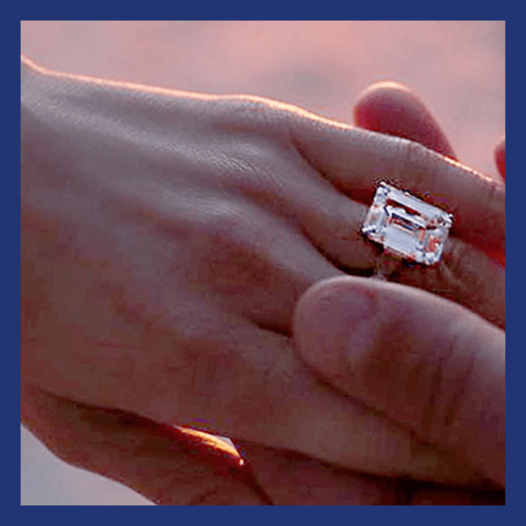 JLo's hand with large emerald cut diamond ring
