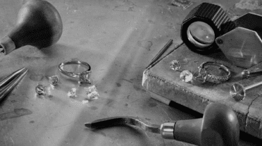 Picture of Ritani diamonds on a table with tools alongside showing craftmanship