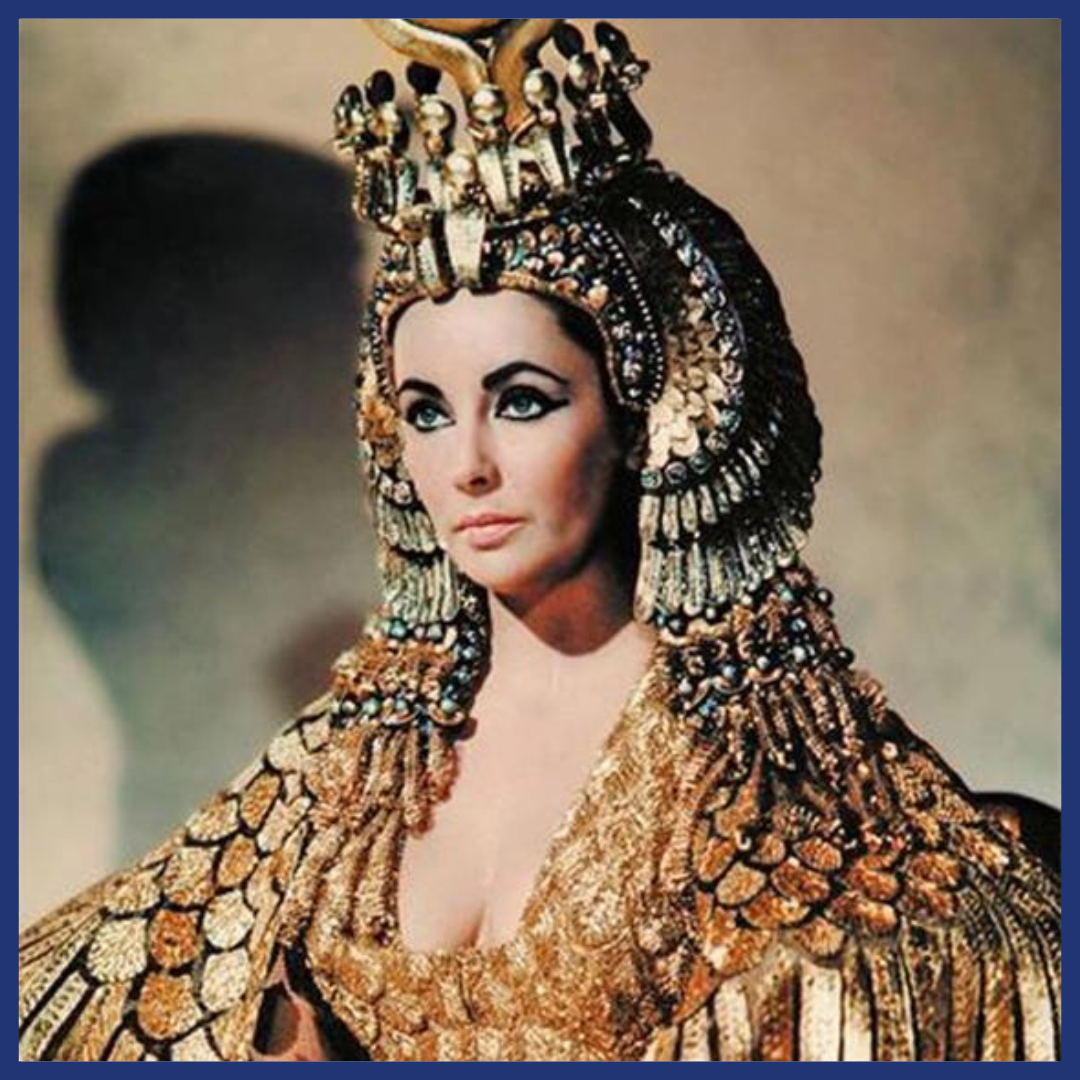 Elizabeth Taylor as Queen Cleopatra wearing a peridot jewel headpiece.