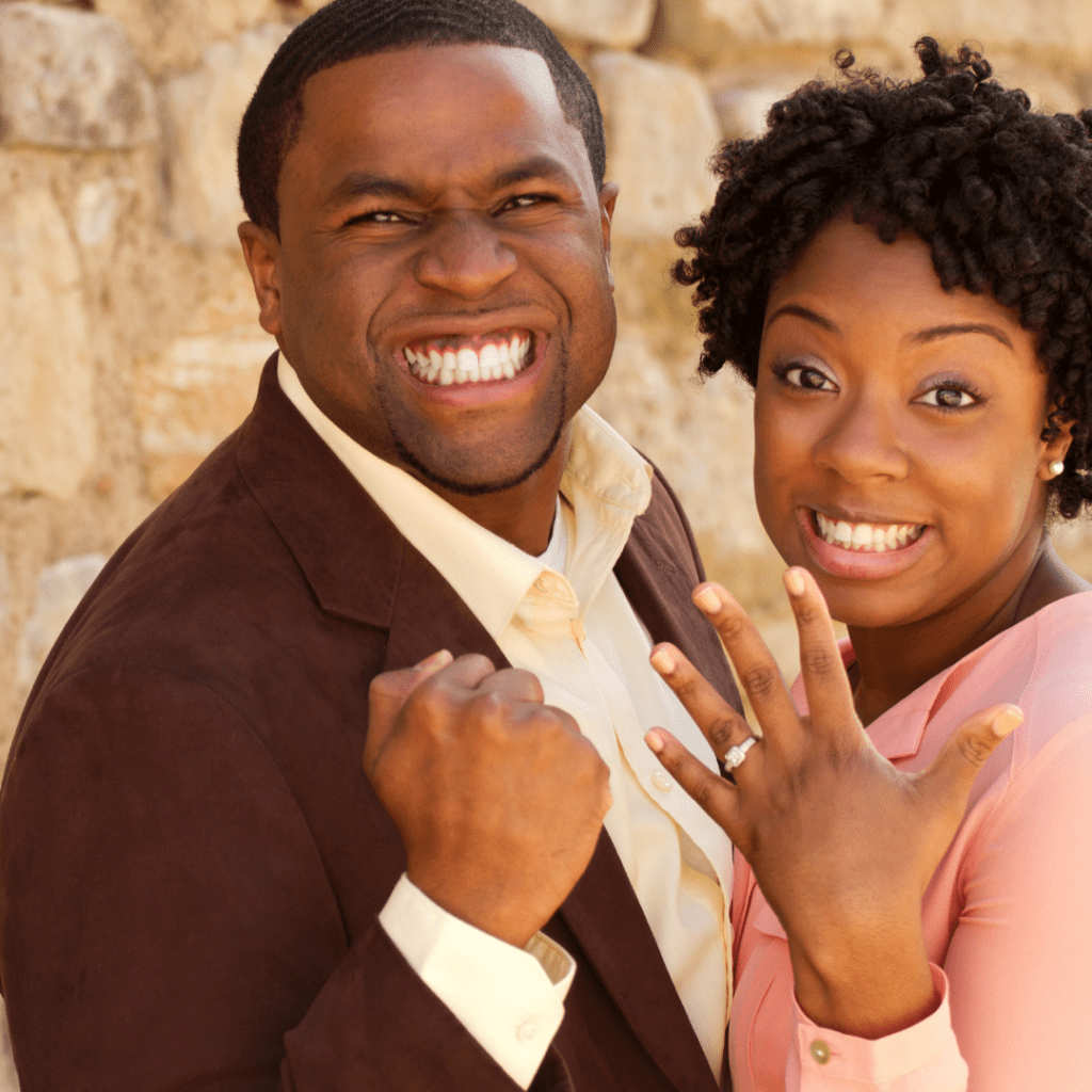 happy smiling couple showing engagement ring