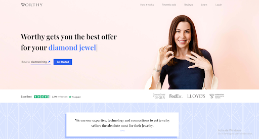 Worthy homepage displaying brunette woman putting a ring on her finger, with the site exclaiming that you will get the best offer for your diamond jewel