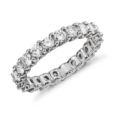 Silver wedding ring band encrusted with diamonds around the exterior of the ring