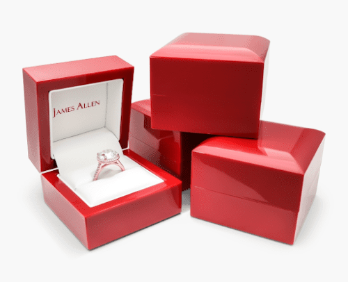 James Allen elegant red packaging, with one ring box open presenting a diamond engagement ring