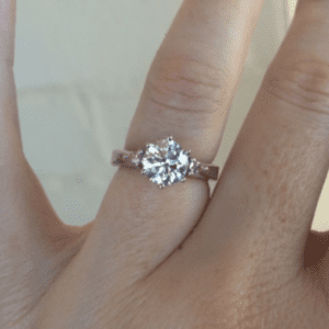 Diamond ring with pink diamond sidestones.