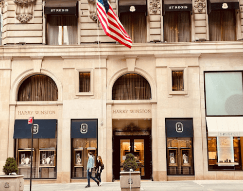 Harry Winston's storefront in NYC, with an American flag flying outside of the store