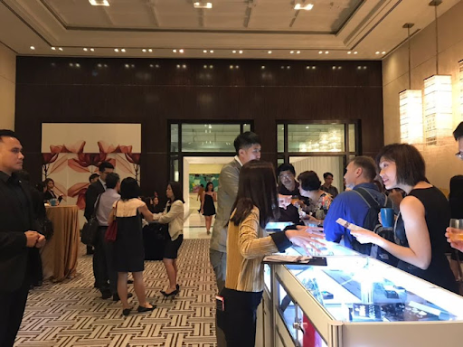 People looking into jewelry display cabinets at the Far East Gems & Jewelry store