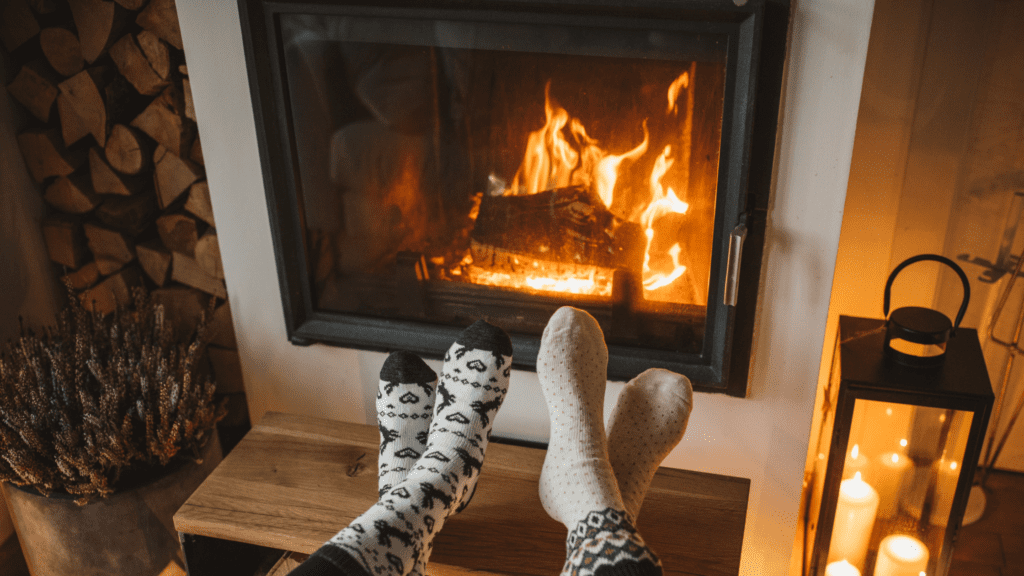 Couple Seated In Front Of A Fireplace