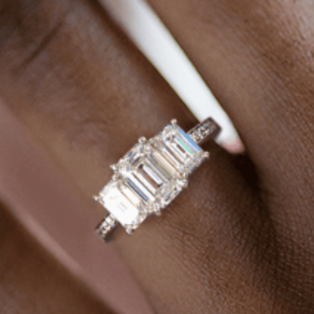 Emerald Cut Diamond Three Stone Emerald And Pavé Set Diamond Engagement Ring