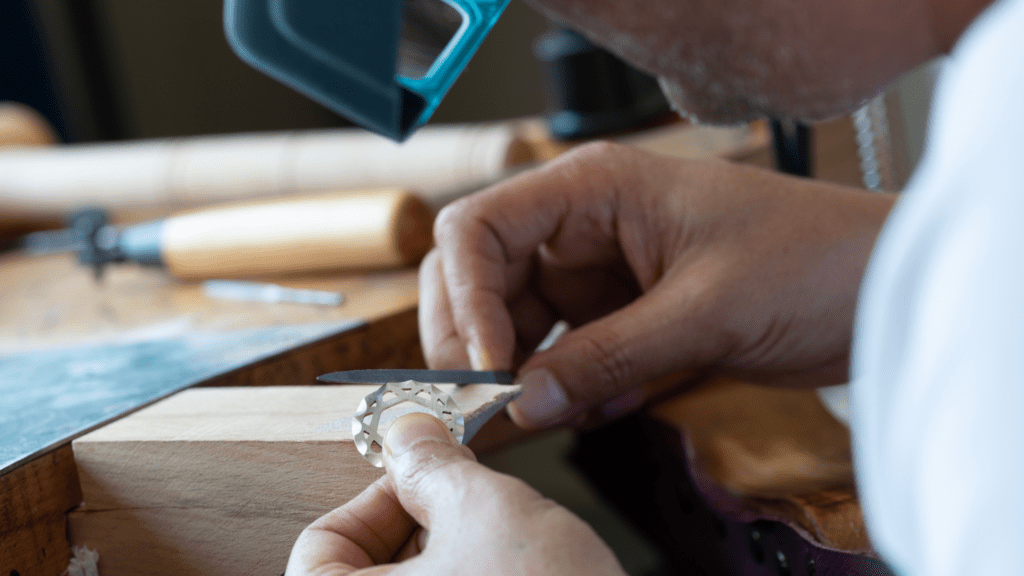 Professional jeweler adjusting a piece of jewelry.