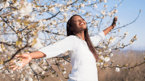 Woman looking serene among cherry blossoms