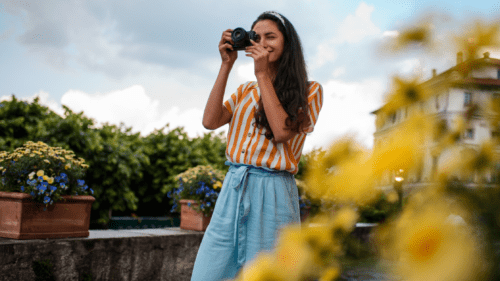 Photographer taking proposal pictures among flowers