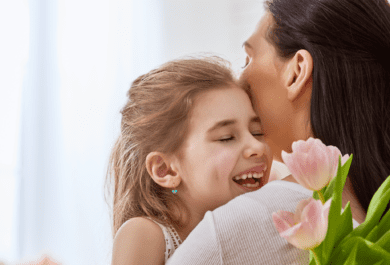 Mother and young daughter embrace