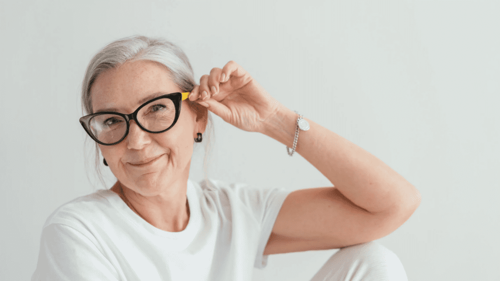 Elderly mum wearing black framed specs.