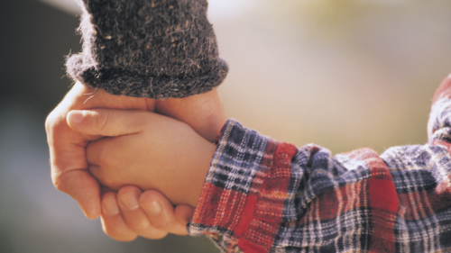 Father and young son holding hands