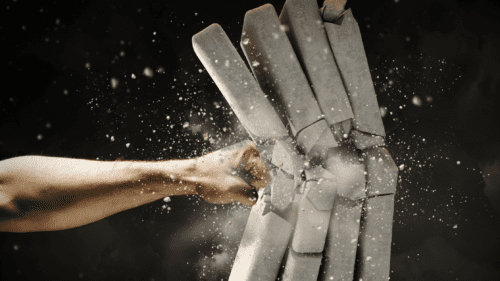 Mohs Strength - hand punching a stack of concrete.